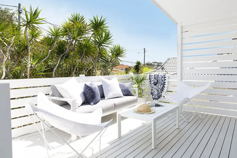 White painted deck with an outdoor lounge
