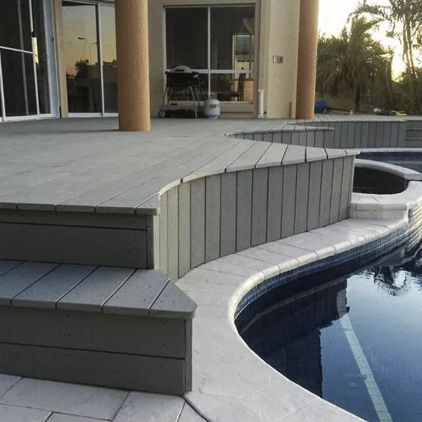 Grey composite deck around a curved pool