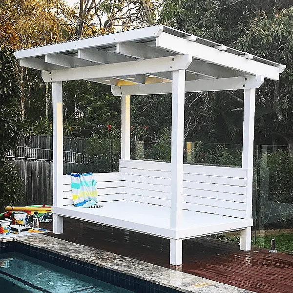 White poolside cabana with a daybed