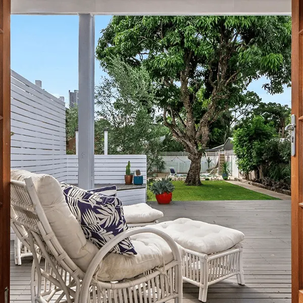 Verandah with cane chairs and a garden view