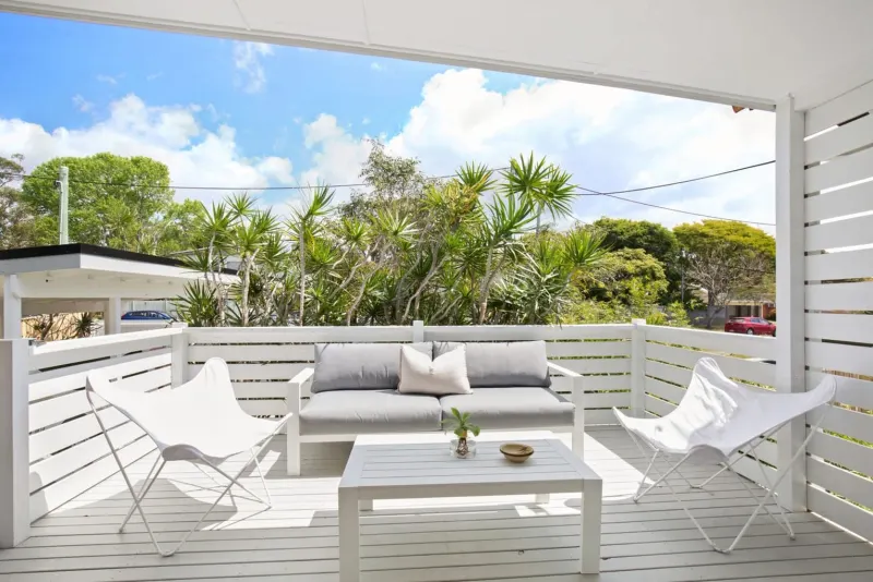 Covered timber deck with an outdoor dining setting